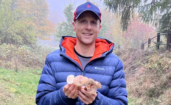 James Hill holding wild foraged mushrooms as a gift, promoting foraging course gift vouchers