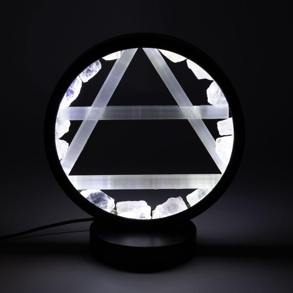 Air gemstone halo lamp with clear quartz and selenite in the dark, shining bright white